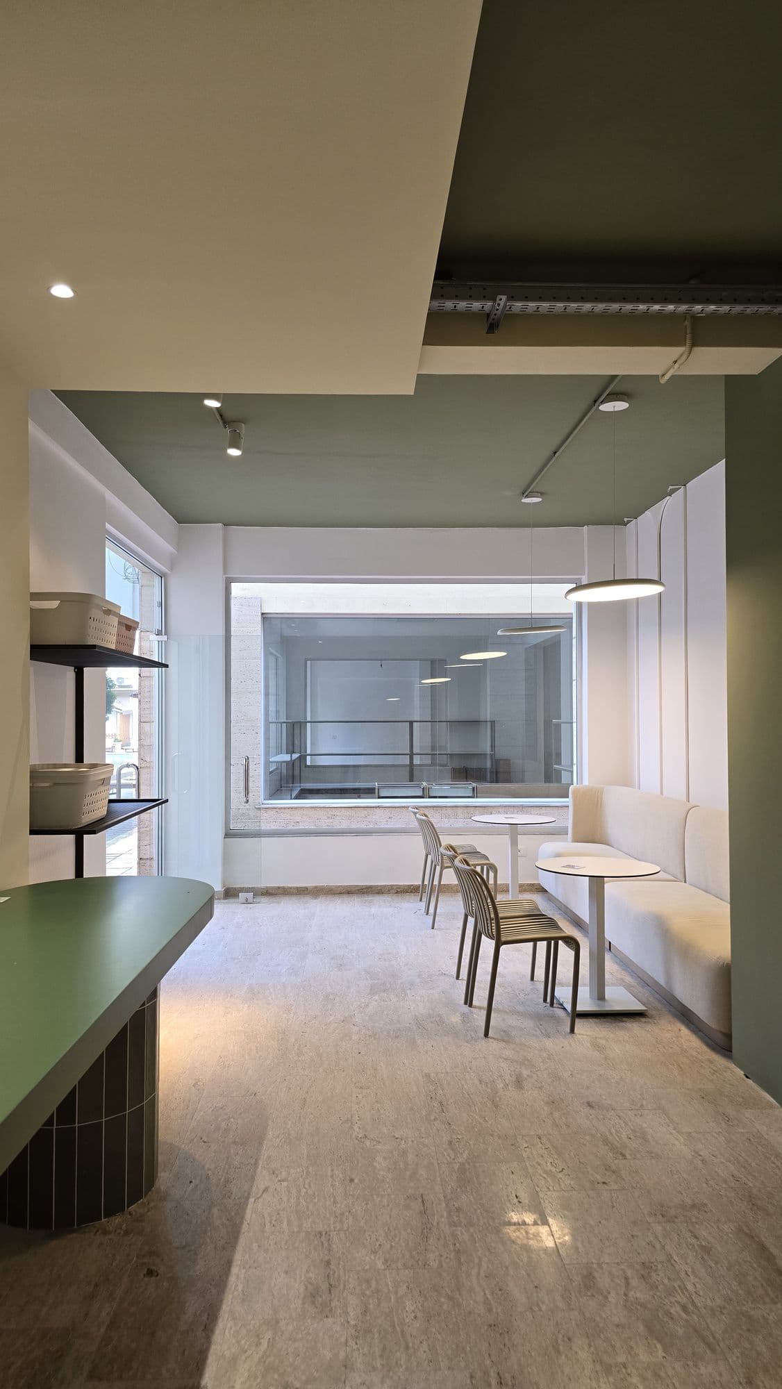Lounge seating with sofas and natural light in the Sip & Spin waiting area